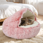 Kitten asleep under the hood of a fluffy donut cat bed
